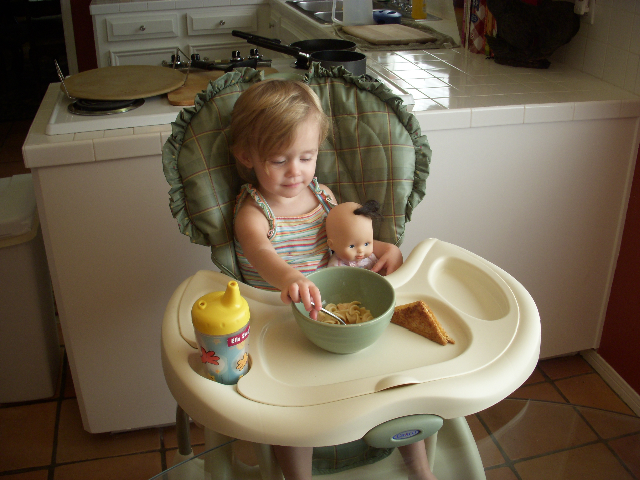 Ella eats with her baby